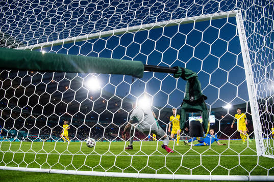 Artem Dovbyk of Ukraine scores 1-2 behind goalkeeper Robin