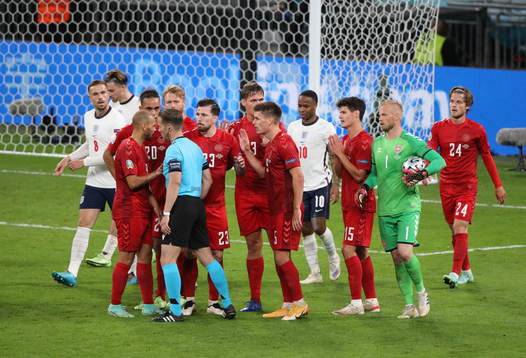 Players of Denmark protest about the penalty decision