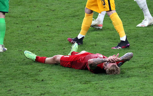 Simon Kjær of Denmark looks dejected