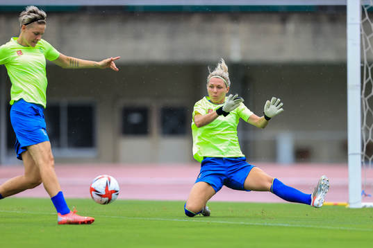 Lina Hurtig and goalkeeper Jennifer Falk of the Swedish