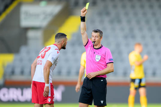 Vadim Bolohan of Milsami Orheis receives a yellow card from