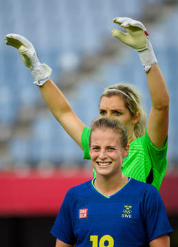 Anna Anvegård and goalkeeper Erin Nayler of New Zealand in