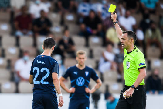 Adi Nalic of Malmö FF is shown a yellow card by Referee
