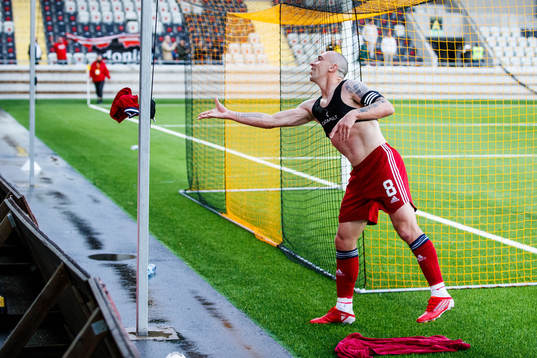 Scott Brown of Aberdeen throws his jersey to a supporter