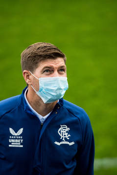 Steven Gerrard, head coach of Rangers inspect the pitch