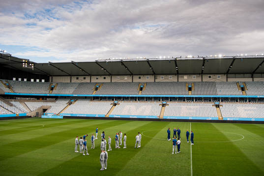 Players of Rangers inspect the pitch