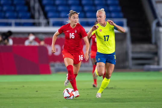 Janine Beckie of Canada and Caroline Seger of Sweden in the