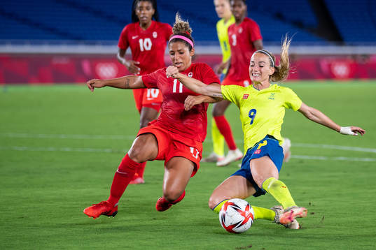 Desiree Scott of Canada and Kosovare Asllani of Sweden in