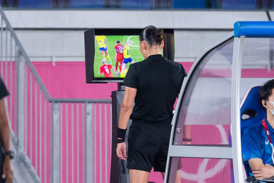 Referee Anastasia Pustovoitova looks at a VAR-checkin the