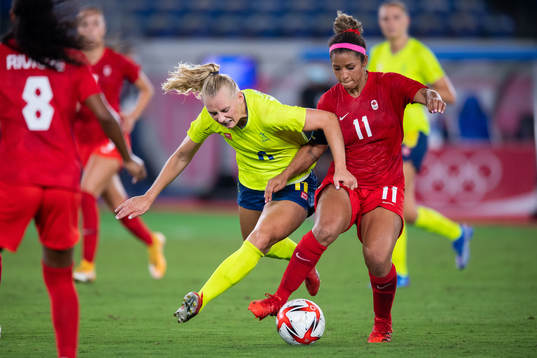 Stina Blackstenius of Sweden and Desiree Scott of Canada in