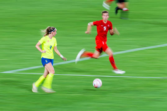 Kosovare Asllani of Sweden and Quinn of Canada in the