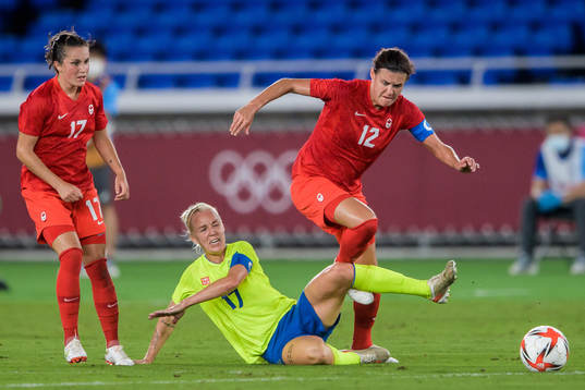 Jessie Fleming and Christine Sinclair of Canada against