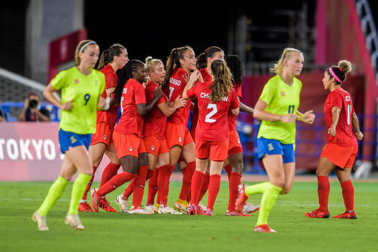 Jessie Fleming of Canada celebrates with teammates