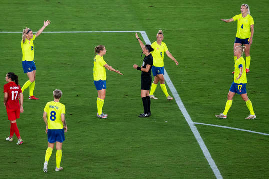 Players of Sweden and referee Anastasia Pustovoitova in the