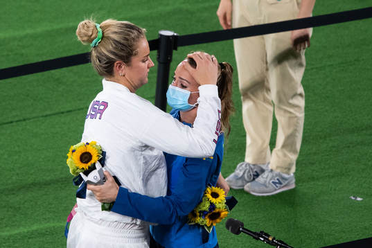 Player of Unites states hugs Kosovare Asllani of Sweden