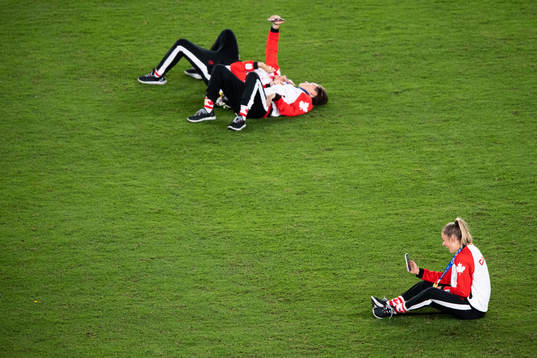 Players of Canada with cellphones