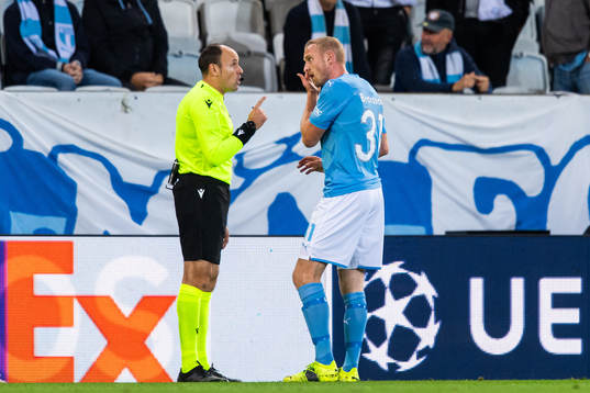 Referee Antonio Mateu Lahoz talks to Franz Brorsson of