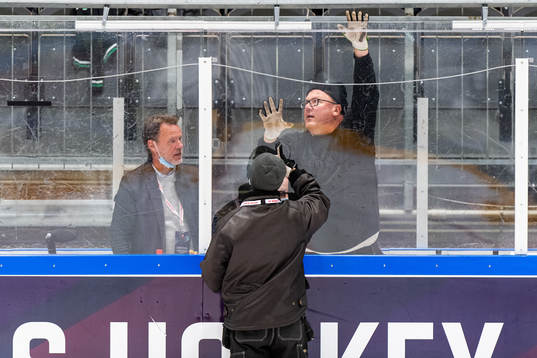 An attendant replaces a piece of plexiglass