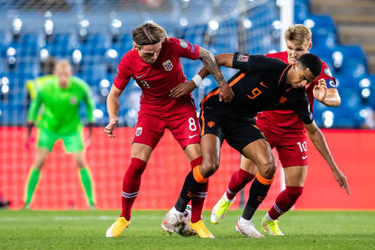 Patrick Berg and Martin Ødegaard of Norway and Cody Gakpo