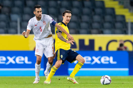 Sergio Busquets of Spain and Kristoffer Olsson of Sweden