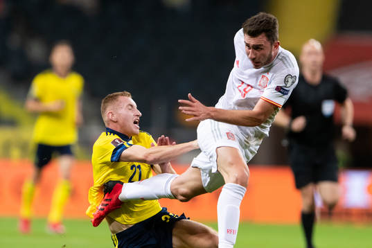 Dejan Kulusevski of Sweden and Aymeric Laporte of Spain
