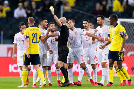 Dejan Kulusevski of Sweden is shown a yellow card