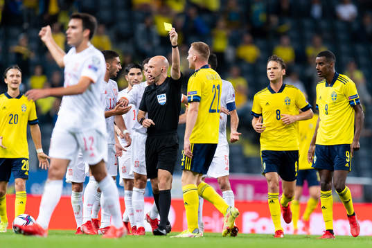 Dejan Kulusevski of Sweden is shown a yellow  card