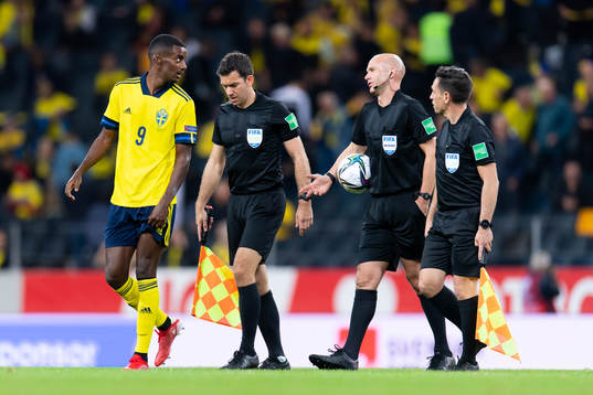 Alexander Isak of Sweden talks to referee Anthony Taylor