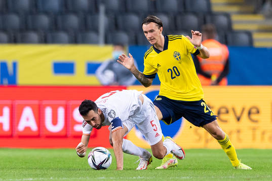 Sergio Busquets of Spain and Kristoffer Olsson of Sweden
