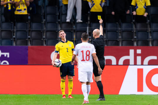 Emil Krafth of Sweden is shown a yellow card