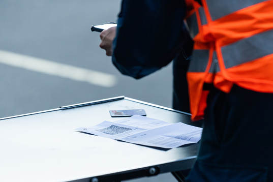 Personel check the Covid passes of arriving spectators