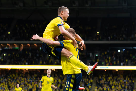 Viktor Claesson and Dejan Kulusevski of Sweden celebrate