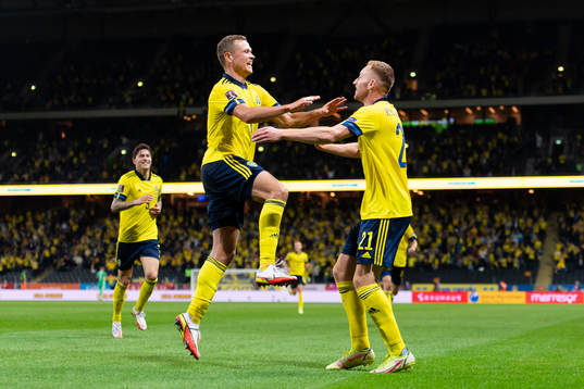 Viktor Claesson and Dejan Kulusevski of Sweden celebrate