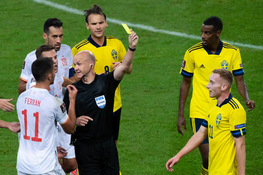 Dejan Kulusevski of Sweden is shown a yellow card