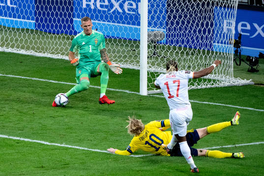 Goalkeeper Robin Olsen of Sweden makes a save when Adama