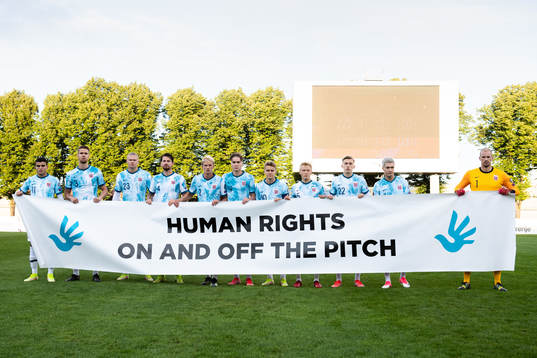 The starting eleven of Norway pose with a sign