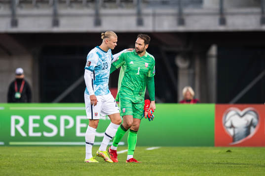 Erling Braut Haaland of Norway and goalkeeper Pavels
