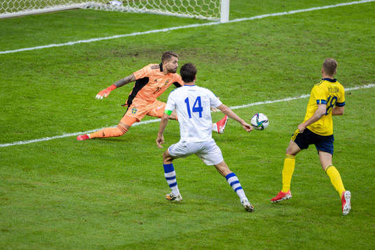 Eldor Shomurodov of Uzbekistan scores 2-1 behind goalkeeper