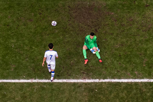 Dostonbek Tursunov and goalkeeper Eldorbek Suyunov of