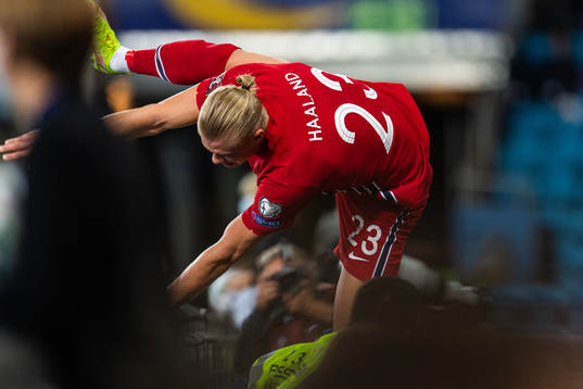 Erling Braut Haaland of Norway jumps over the advertising