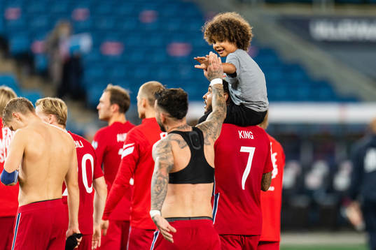 Aron Dønnum of Norway greets the son of Joshua King