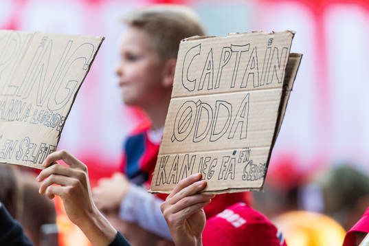 A fan holds up a sign directed to Martin Ødegaard of Norway