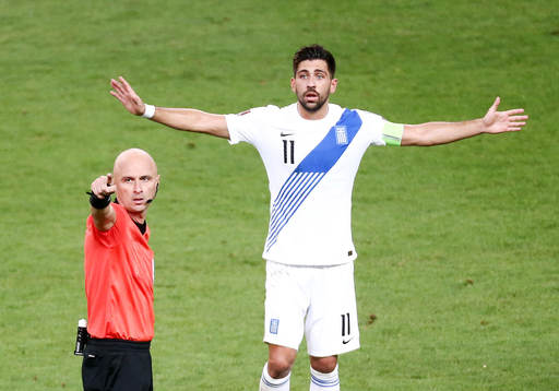 Referee Sergei Karasev and Tasos Bakasetas of Greece