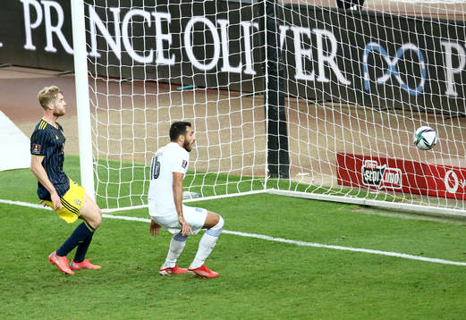 Filip Helander of Sweden sees Vangelis Pavlidis of Greece