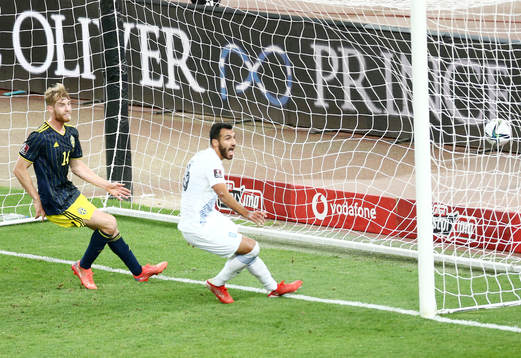 Filip Helander of Sweden sees Vangelis Pavlidis of Greece