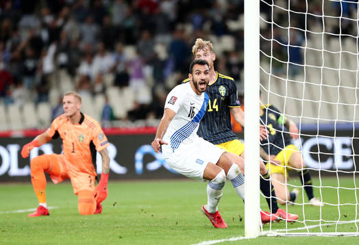 Filip Helander of Sweden sees Vangelis Pavlidis of Greece