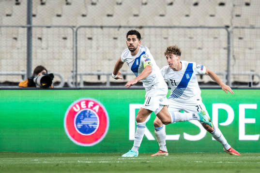Tasos Bakasetas and Kostas Tsimikas of Greece celebrate the