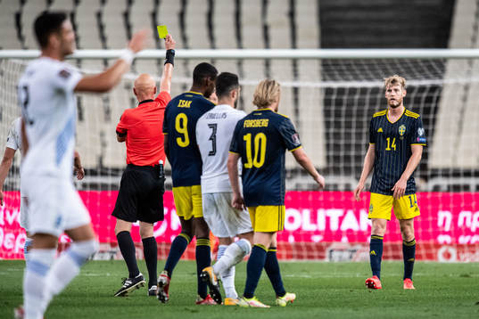 Filip Helander of Sweden is shown a yellow card by referee