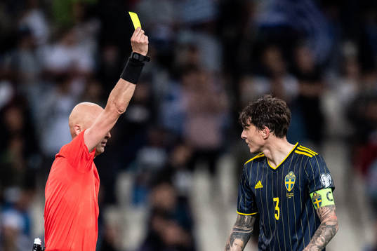 Victor Nilsson Lindelöf of Sweden receives a yellow card