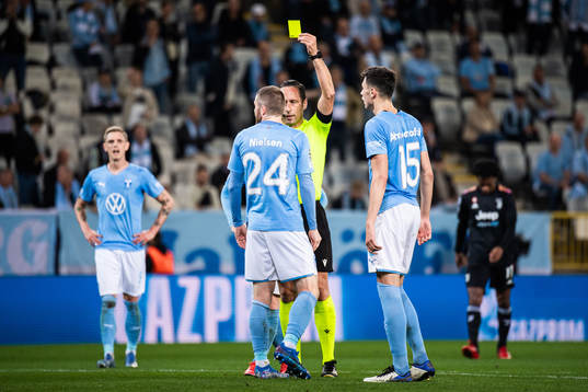 Lasse Nielsen of Malmö FF receives a warning from referee